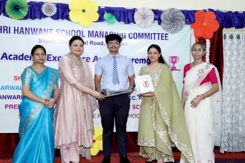 Student receiving academic excellence award on stage